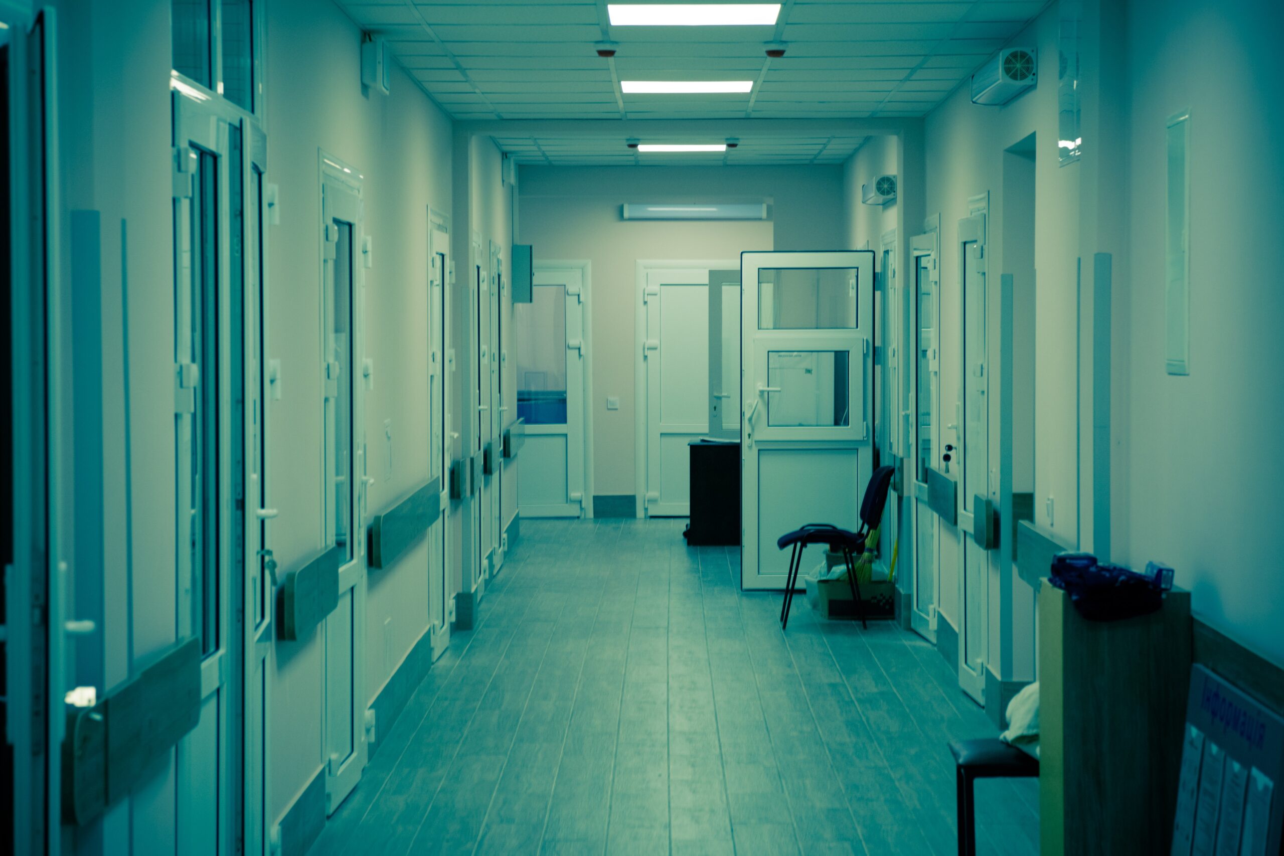 Greenish photograph of a hospital corridor.